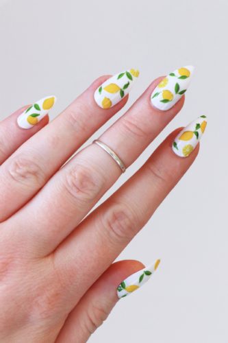 White stiletto nails with lemon nail art