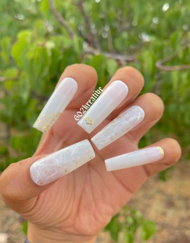 Long milky white marble nails with gold accents