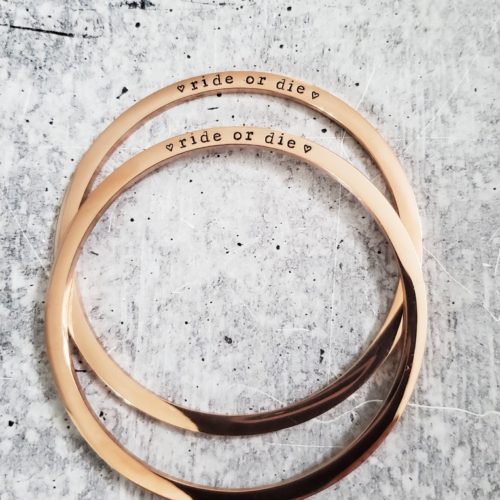 Gold bangles engraved with the words 