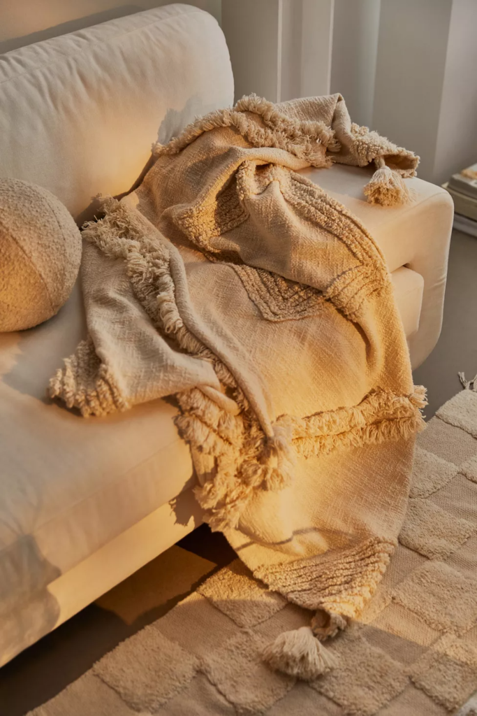 Beige tufted throw blanket from Urban Outfitters
