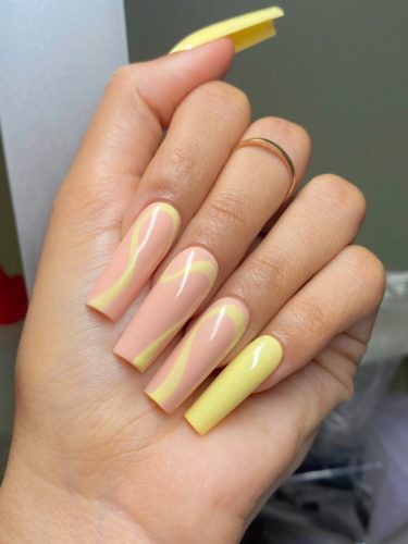Yellow and nude swirl nails