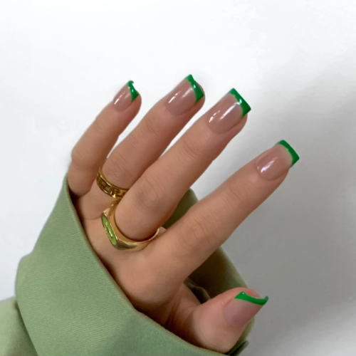 Bright green tip french nails in a square shape