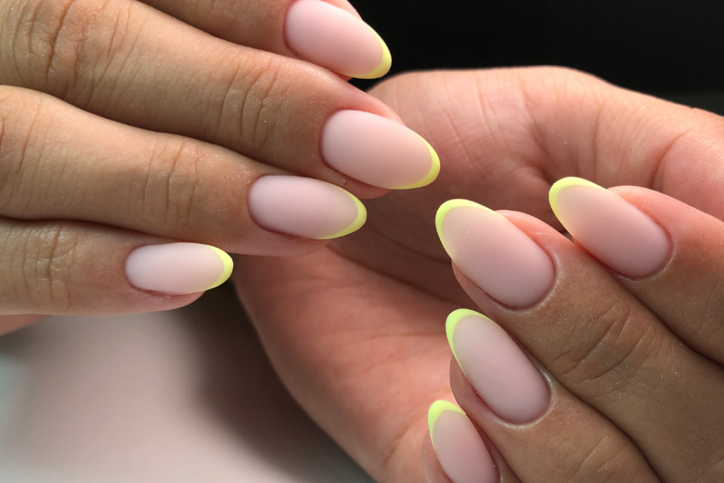 Fluro matte french tip nails in an almond shape