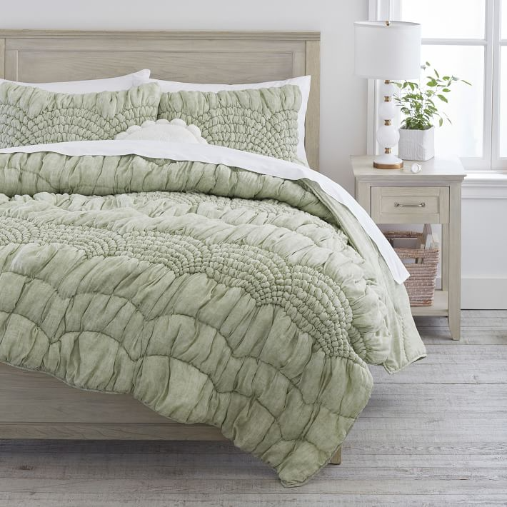 Light green ruffled quilt and sham