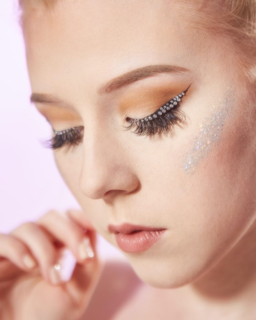 Photo of a person with glitter on their face from unsplash