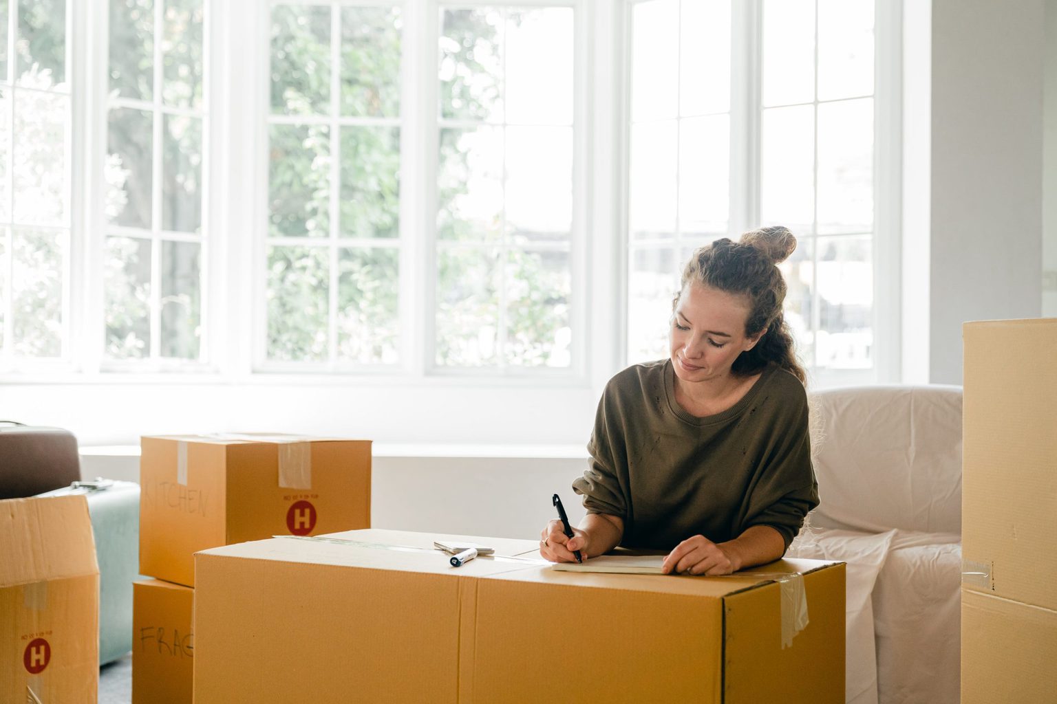 Woman labeling her moving boxes