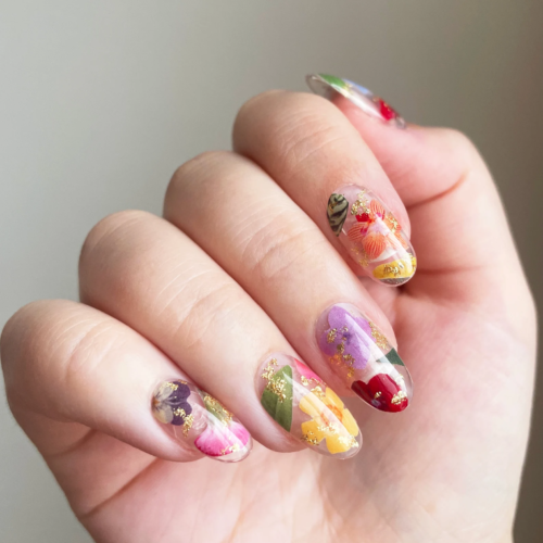 Pressed flower manicure with gold foil accents