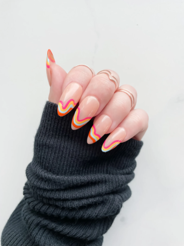 Retro rainbow swirl tip nails in an almond shape