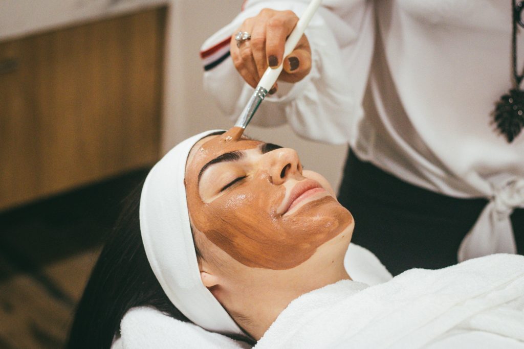Photo of a woman at a spa getting a facial from unsplash