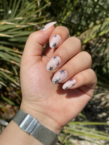 Light pink almond shaped nails with silver stars