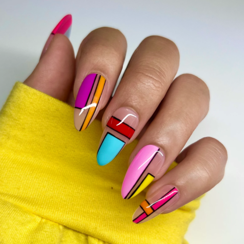 Tetris nails in blue, pink, yellow, and purple with black outlines