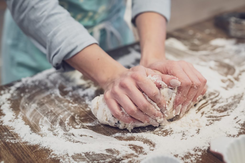 Photo of a person kneading bread from unsplash - 20th birthday ideas