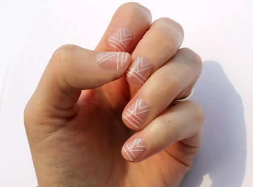 Short nails with white line detailing over clear polish