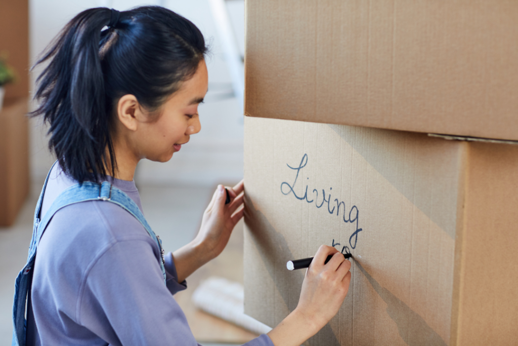 Woman packing box for living room