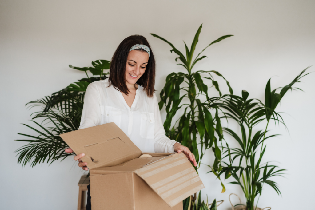 Woman with an open first box of essentials on moving day