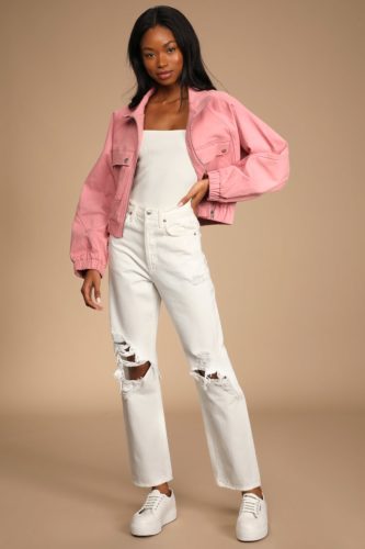 White Jeans outfit with ripped white wide leg jeans and a pink jacket and white bodysuit, paired with white sneakers