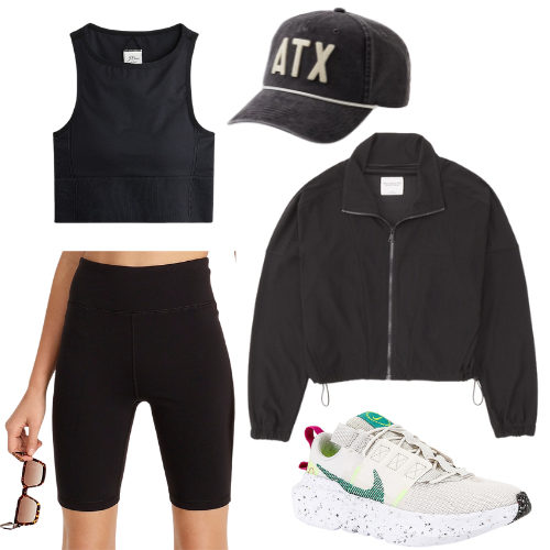 Summer Travel Outfit 2 - black sports bra top, black biker shorts, black zip up, baseball hat and sneakers