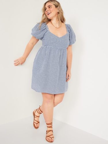 A blue gingham puff sleeve mini dress and gladiator sandals.