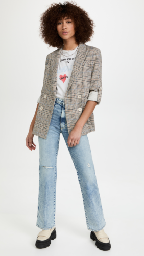 Light wash flares paired with a checked blazer, graphic tee, and chunky loafers