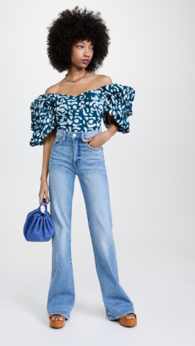 Flare jeans outfit with statement off shoulder top, mini purse, platform heels