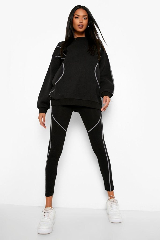 A black contrast stitch sweat and leggings matching set and white sneakers.