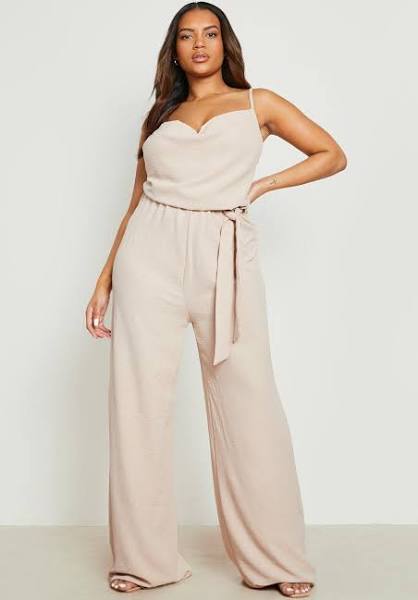 A beige jumpsuit with belt and heels.