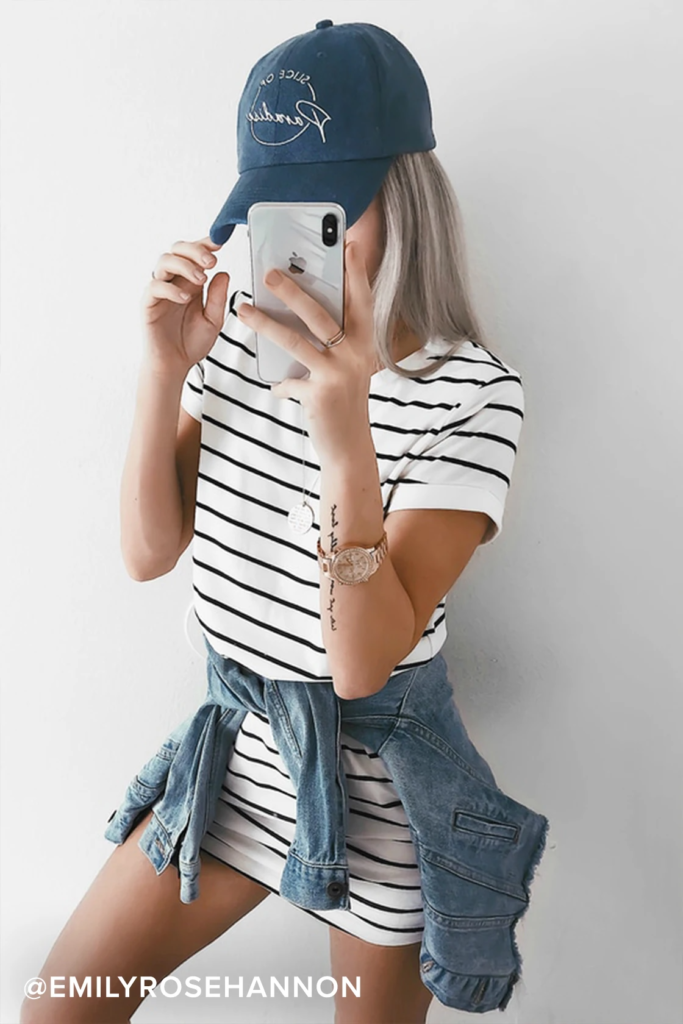 Striped dress, jean jacket and hat outfit for a baseball game