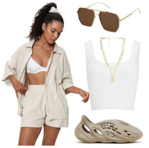 Yeezy Foam Runners Outfit: beige Terry cloth shorts and shirt set, white cropped tank top, layered gold necklaces, gold metal sunglasses and Yeezy Foam Runners