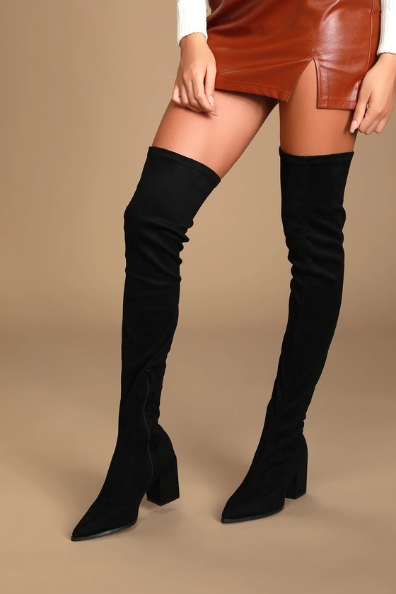 A pair of black suede over the knee pointed toe boots.