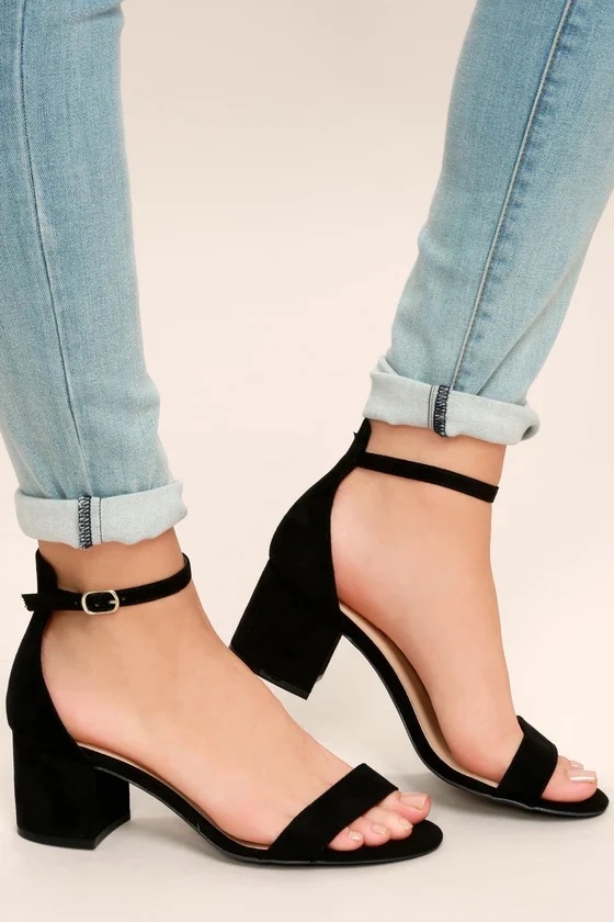 A pair of black ankle strap block heels.
