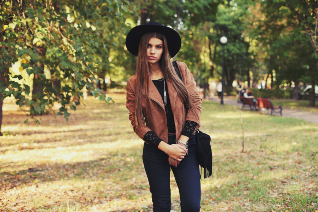 Woman posing with fall trees in the background