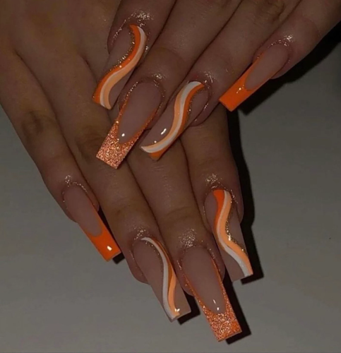Orange glow swirl nails with glitter in a long square shape