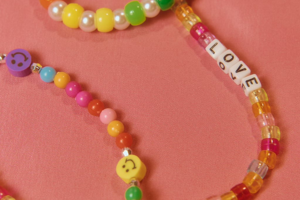 Close-up of friendship bracelets with smiley face beads