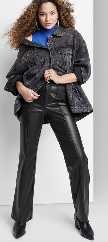 An outfit with black faux leather pants and black ankle boots.