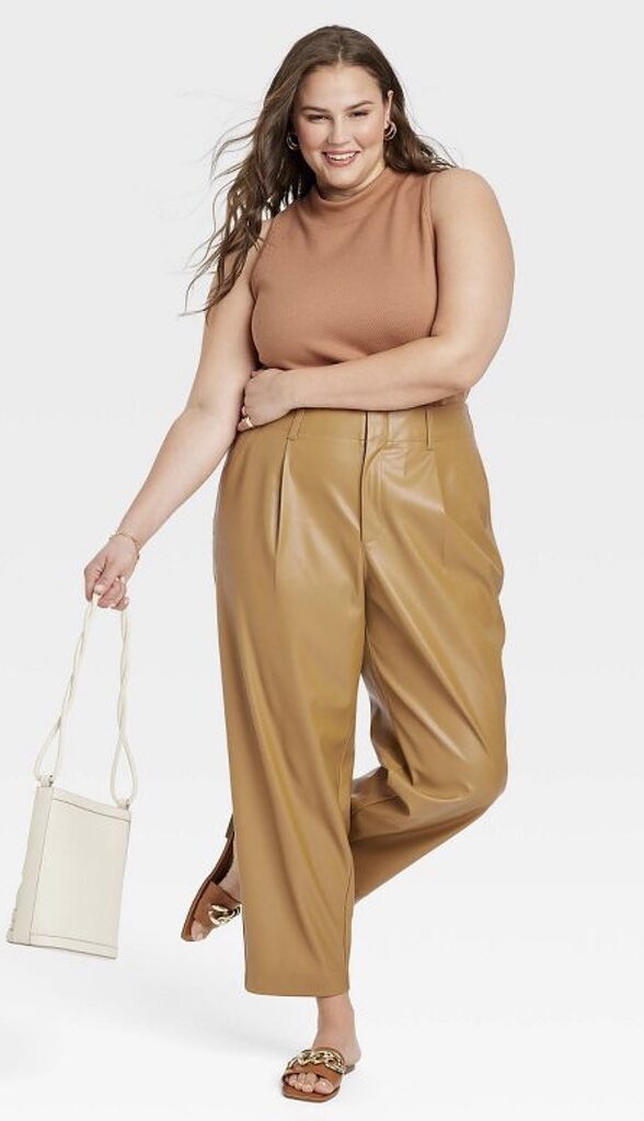 An outfit with brown faux leather tapered ankle pants and brown gold chain strap sandals.