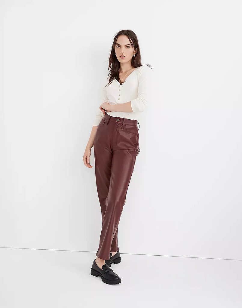 An outfit with burgundy faux leather straight leg pants and black loafers.