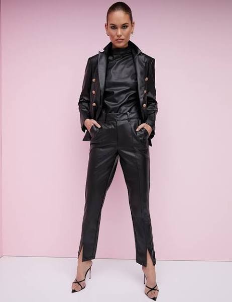 An outfit with high rise black faux leather slit front ankle pants and black stiletto strap heels. - leather trousers, classic style