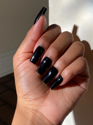 Glossy black acrylic nails in a square shape