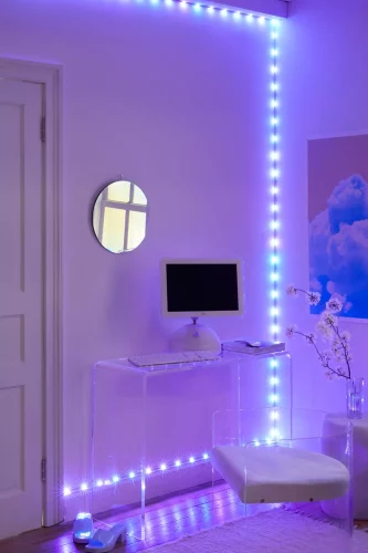 indigo LED light strip in room with acrylic furnitures and an orchid