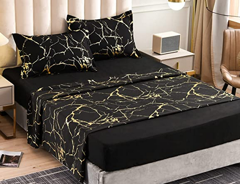 marble bedding that is black with gold metallic on a made bed