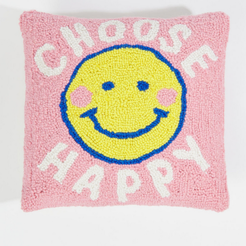 textured square pillow with a smiley face on a pink background that says choose happy