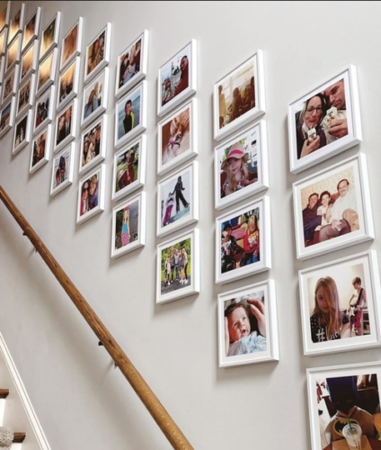 small white square framed pictures on a staircase