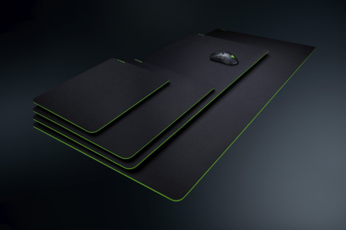stack of razer desk mats/mouse pads with razer mouse on them