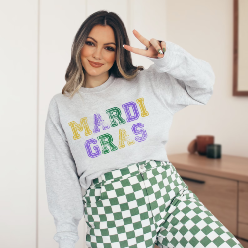 Graphic Mardi Gras sweatshirt worn with green and white checkerboard pants