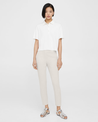 Business casual outfit for summer with linen pants, white blouse, and silver statement shoes