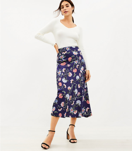 Business casual outfit idea: Floral midi skirt, heels, and a white long-sleeve tee