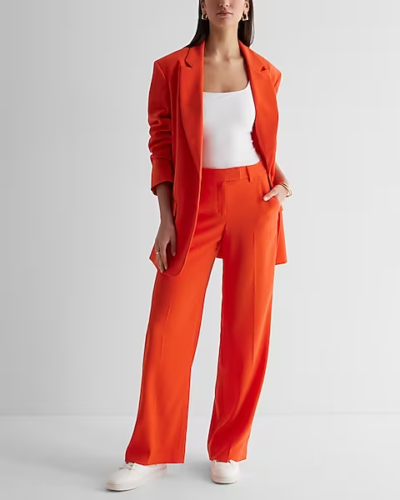 Business casual outfit with bright orange suit, white bodysuit, white sneakers