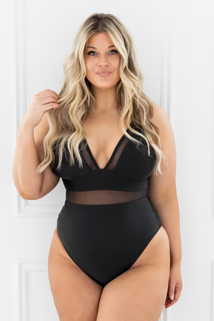 Best bathing suits for curvy girls: Black one-piece with sheer stomach cutout