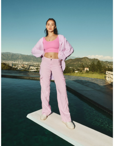 Pastel soft girl outfit with pink cargo pants, pink crop top, oversized pink shirt and sneakers