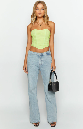 Simple and basic corset top outfit with neon green corset, low rise light wash wide leg jeans, layered necklaces, black handbag and black strappy heels